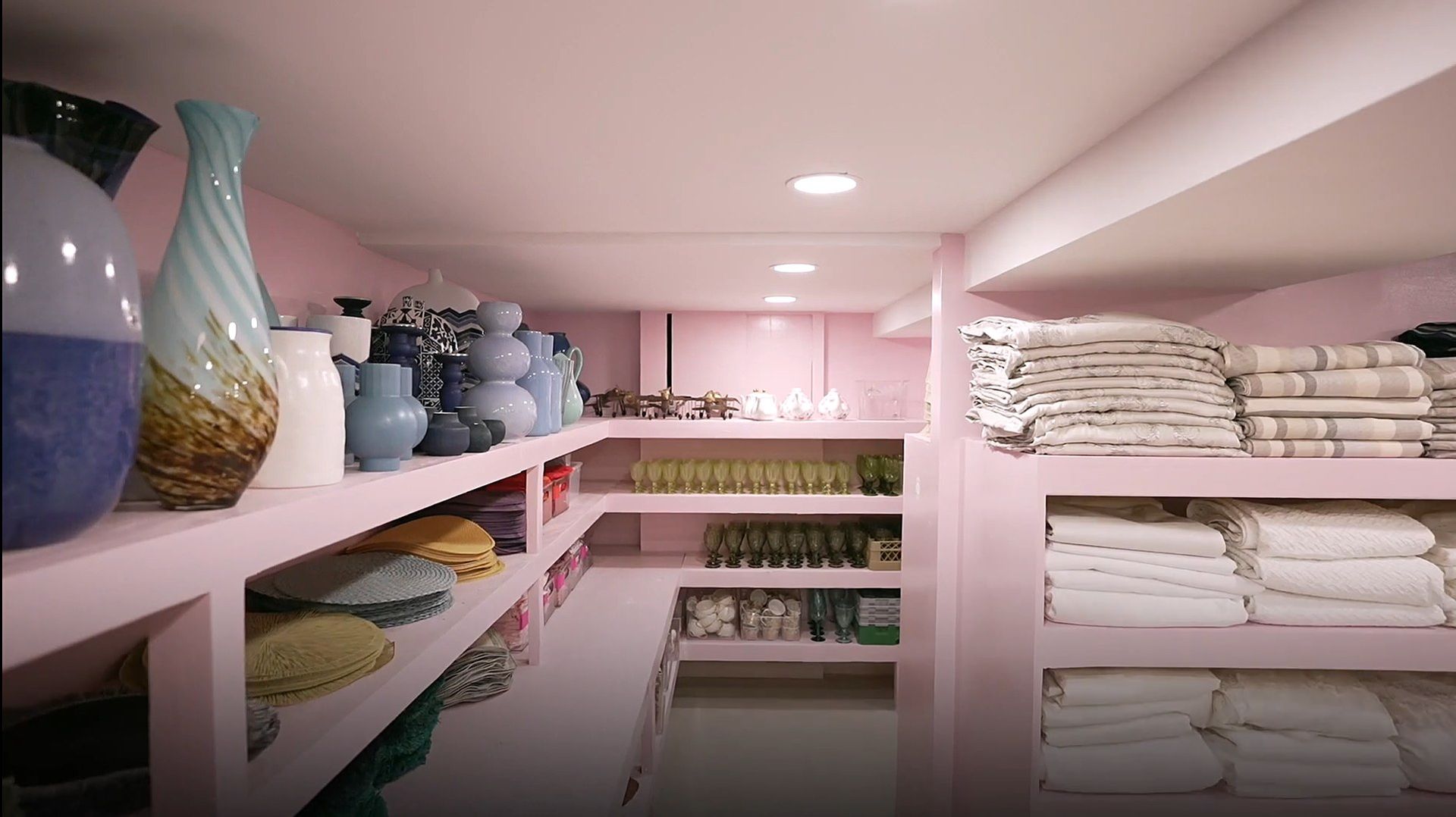 Shelves of vases, placemats, goblets and linens at the gemach