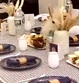 Table with pampas grass and navy chargers